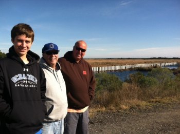 Carson O'Neal, Vince O'Neal, and Darren Burrus at the Ocracoke Community Park. Carson is a freshman at Ocracoke School, a pitcher, and a first baseman. Darren is a former owner of the park property who's been volunteering to help build the bulkhead. 